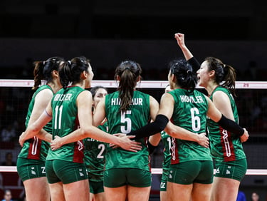 Energetic team huddle of local volleyball players in emerald uniforms celebrating a point, high-contrast indoor stadium lighting, 35mm.