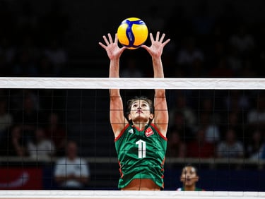 Tight crop on athletic movement, hands blocking a volleyball at the net, dramatic court spotlights, high-contrast, 35mm.