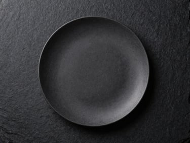 Minimalist high-end culinary plating mockup on a dark slate background, professional studio lighting, focus on texture and composition