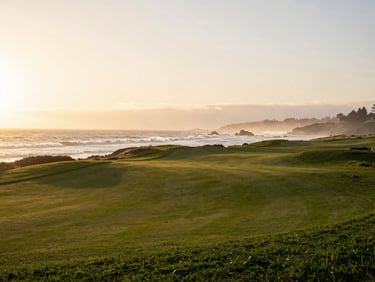 Serene view of the 18th hole at Pebble Beach at sunset, waves crashing softly against the cliffs, golden-hour light, 35mm