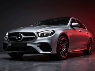 Dramatic low-angle shot of a metallic silver Mercedes-Benz E-Class sedan, sharp reflections, modern showroom lighting, 35mm prime lens, deep graphite and crimson tones.