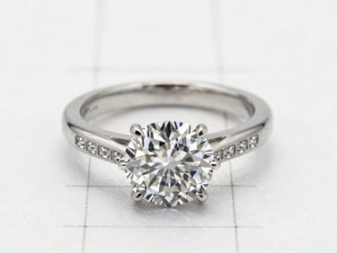 A precise graphite technical drawing of a diamond ring layout, showing micro-pave grid lines on archival vellum, soft diffused daylight, macro details