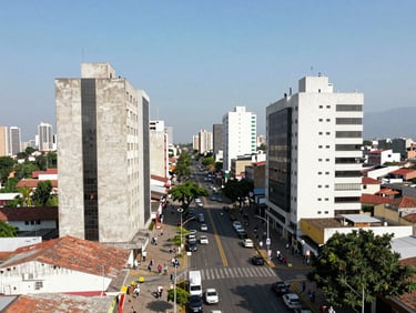 Aerial view of Bucaramanga's main avenues, light traffic, modern city architecture, clear sky, editorial photojournalism.