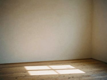 An empty sunlit room with raw plaster walls, light casting a sharp geometric shadow on the wooden floor, quiet atmosphere.