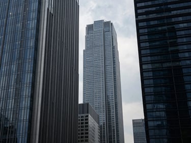 Modern financial district skyscrapers, architectural details, high-contrast, cinematic, premium editorial photography, deep navy and steel tones, architectural framing, 35mm
