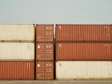 Shipping containers stacked at Jawaharlal Nehru Port, wide shot, warm daylight, focus on scale and organization, low horizon, 35mm film aesthetic.
