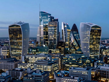 High-altitude aerial view of the London financial district at twilight, sharp architectural lines of skyscrapers, cool blue tones contrasted with warm golden office lights.