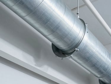 Macro architectural photograph of a pristine commercial HVAC duct interior, clean metallic surfaces, sharp focus, technical lighting.