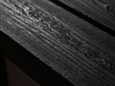 Extreme close-up of fumed oak grain meeting charred wood texture, low-key lighting, deep shadows, tactile luxury