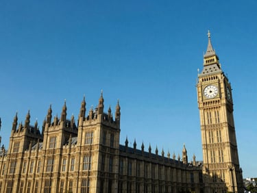 Wide-angle architectural shot of the London Palace of Westminster and Big Ben under bright morning daylight, sharp focus, rich blue sky.