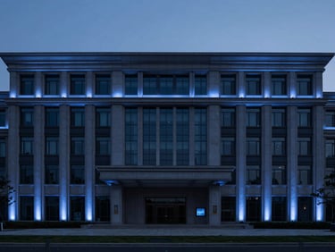 Modern government building facade at twilight, subtle blue uplighting, wide environmental shot.