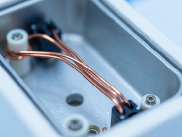 Close-up of the internal copper wiring of a dilution refrigerator, sharp focus, clinical studio lighting.