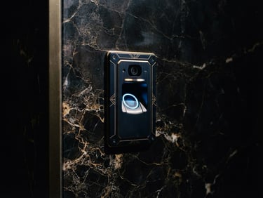 Low-key dramatic side-lighting on a close-up of a high-end biometric security scanner integrated into a dark marble wall, architectural context, 35mm