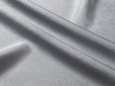 Close-up of slate gray cooling ice silk fabric with subtle technical weave pattern, bright studio light, sharp focus