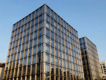Modern commercial office building exterior, clean steel and glass architecture, bright crisp daylight.