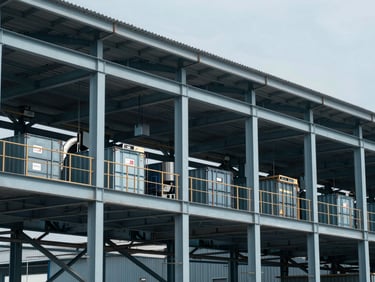Crisp editorial photography of an active industrial logistics facility in cool daylight, steel structures, sharp focus, 35mm lens