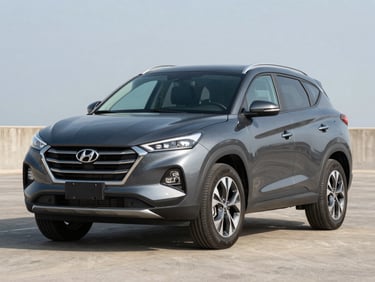 Three-quarter front view of a dark gray Hyundai Tucson SUV on clean pavement under bright daylight, David Chiriquí, no people