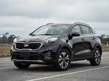 Three-quarter front view of a black Kia Sportage crossover on clean asphalt under overcast daylight, Chiriquí Panama, no people