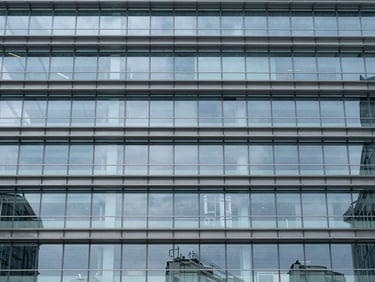 Commercial infrastructure asset, glass and steel structural grid, clean lines, architectural scale.