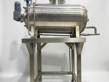 Industrial stainless steel horizontal pressure vessel tank on a metal stand for chemical processing.