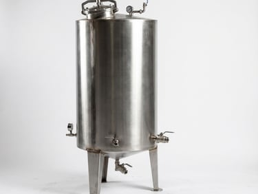 Industrial stainless steel storage tank with pressure gauge and valves for chemical or food processing.