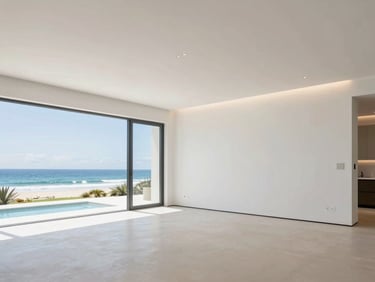 Wide shot of a clean, modern luxury home interior featuring integrated lighting and subtle plumbing elements, bright coastal daylight, 35mm