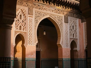 Intricate Islamic architectural details of a riad courtyard in Marrakech, warm terracotta tiles, soft golden hour sunlight, cinematic depth of field.