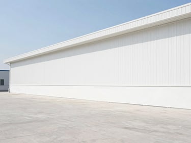 Wide architectural shot of a clean, bright industrial warehouse floor, bright daylight, high clarity, stark before-and-after proof of competence