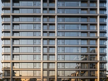 Dramatic architectural render of Brigade Neopolis facade, floor-to-ceiling glass, crisp daylight, sharp focus.