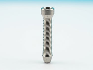 Macro photograph of a sterile titanium hip replacement stem, high-key clinical studio lighting, sharp focus on textured surface