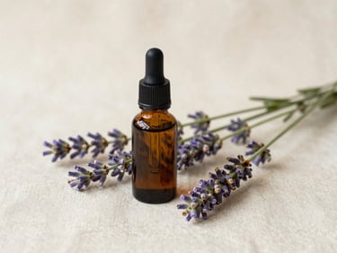 Close-up of a small amber glass dropper bottle of essential oil next to fresh lavender sprigs on a cream linen, soft diffused daylight.