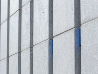 Ultra-sharp macro photograph of structured geometric patterns on a modern concrete wall, cool daylight, minimalist composition
