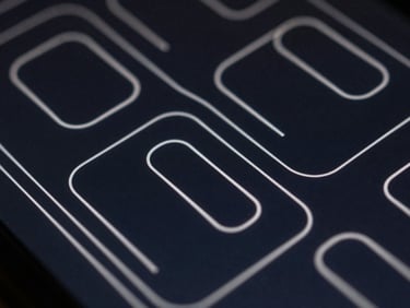Extreme macro close-up of high-fidelity UI/UX wireframes on a dark screen, sharp silver lines, deep navy background, technical precision.
