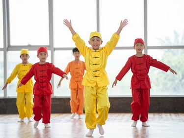 Young children in colorful costumes performing a dance on a bright stage