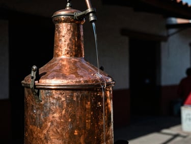 Close-up of clear mezcal dripping from a copper still in a rustic palenque, high-contrast shadows, film grain
