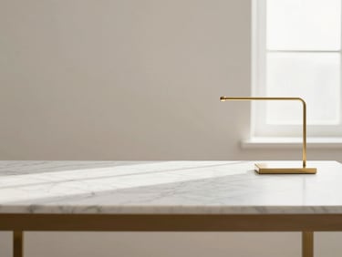 Minimalist desk setup with premium marble and brass materials under soft natural light, warm off-white tones, clean composition, 35mm lens
