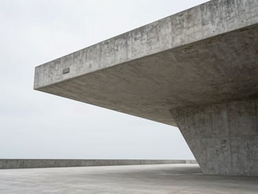 Structured architectural detail of a concrete pavilion with sharp geometric lines, soft diffused overcast daylight, expansive negative space.