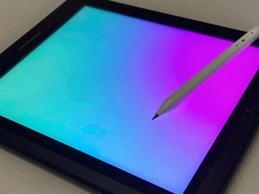 A high-tech digital drawing tablet with a glowing stylus pen active, vibrant cyan and magenta screen glow.