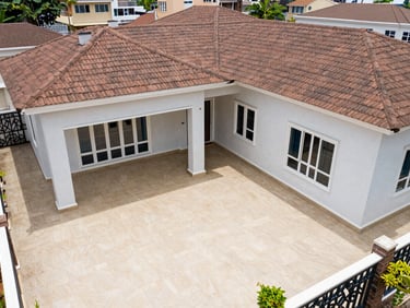 Overhead wide shot of a three-bedroom residential property in Lekki, Lagos — tiled courtyard, natural daylight, no people, clean architectural documentation