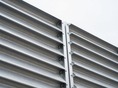 Close-up of industrial heavy-duty aluminum louvres, sharp focus on mechanical linkages, cool-toned industrial daylight, 35mm