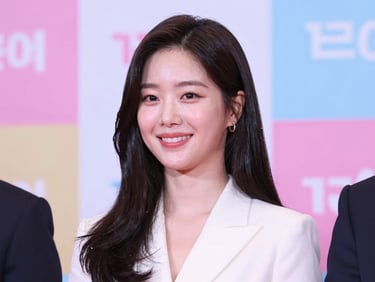 Candid elegant photo of a famous Korean actress smiling warmly at a press event, soft romantic studio lighting