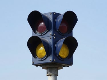 Close-up of a modern railway signaling LED lamp unit on a steel mast, high contrast