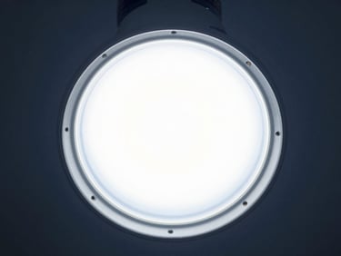 High-efficiency LED bulb, frosted diffuser, cool high-key laboratory light, sharp metallic textures
