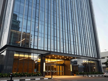 Daylight exterior of a completed commercial office building in Accra, glass facade, ground-level entrance visible, architectural lighting, no people