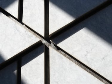 Abstract architectural detail of premium white marble and dark steel joints, sharp shadows, high contrast sunlight