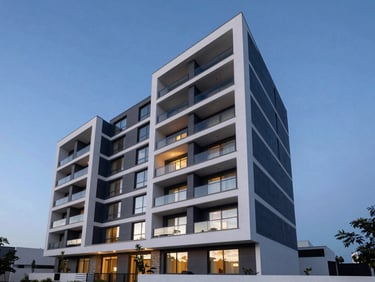 Wide-angle architectural shot of a luxury modern residential building with clean geometric lines, twilight blue-hour lighting, premium Mexican design