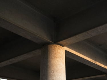 Extreme close-up of structural steel beams meeting concrete column, dramatic architectural lighting, sharp focus