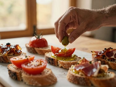 Close-up of artisanal tapas being assembled, heirloom tomatoes, olive oil, jamón on rustic bread, soft lighting