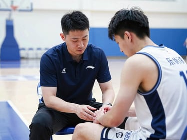Certified athletic trainer attending to an athlete with a minor injury on the sidelines of a basketball court, bright indoor lighting, focused and professional.