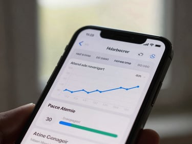 Close-up of an iPhone displaying an ad manager dashboard with real-time conversion graphs, natural window side-lighting.